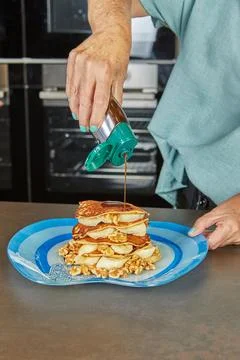 Pouring syrup over pancake stack Stock Photos