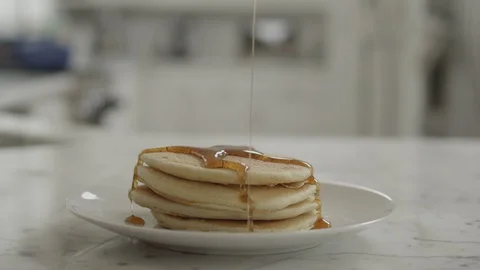 Pouring Syrup over a small stack of pancakes Stock Footage 127598494