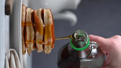 Pouring syrup over stack of pancakes. Homemade breakfast, vertical video Stock Footage 261569165