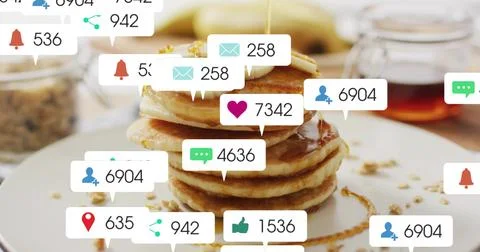 Pouring syrup over stack of pancakes with banana at breakfast table, showing Stock Photos