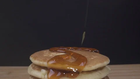 Pouring syrup onto small pancake Wide angle Macro sliding Video stock 124013632