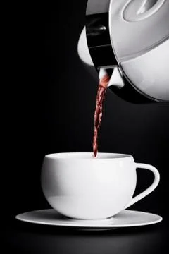 Pouring tea on black background Stock Photos