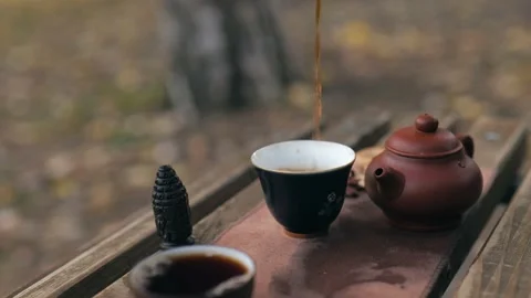 Pouring tea into bowls Stock Footage 229861239