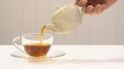 Pouring tea from ceramic teapot Stock Footage 109560596