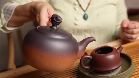 Pouring tea from a Chinese kettle Stock Footage 217369853