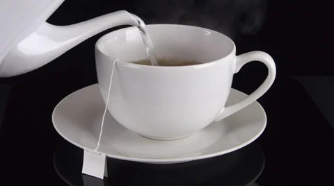 Pouring Tea into a Cup Angled View Stock Footage 29269284