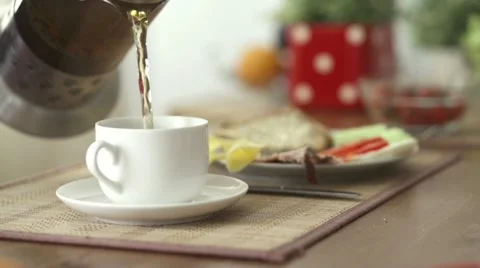 Pouring tea in cup HD Stock Footage 12365335