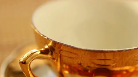 Pouring tea into the cup from kettle Stock Footage 47695666