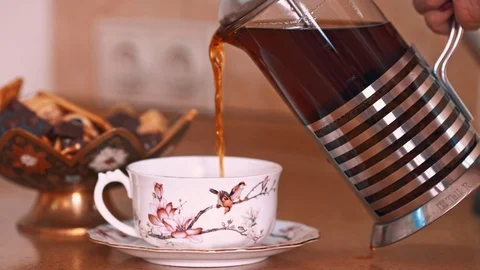 Pouring tea into cup from teapot Video stock 99660029