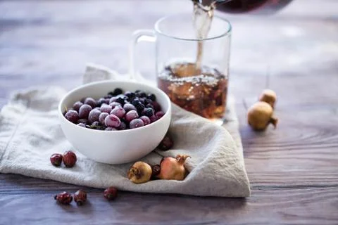 Pouring tea into a glass cup Stock Photos