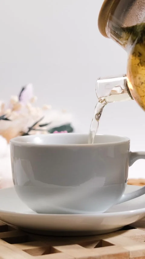 Pouring tea with lemon slice into glass cup Stock Footage 318314979