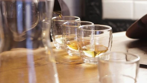Pouring tea or coffee into cups. Barista making irish coffee close up. Stock Footage 126852641