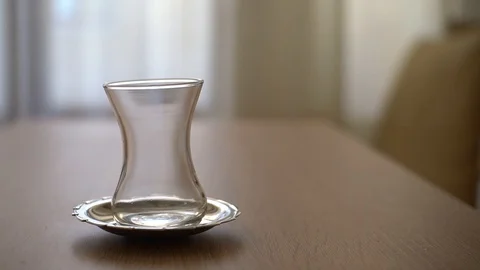 Pouring tea out of pot in a classical traditional tea glass 2 times Slow Motion Stock Footage 129419929