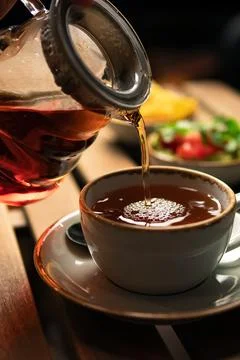 Pouring tea Stock Photos