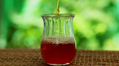 Pouring Tea Into A Small Glass Stock Footage 135138311