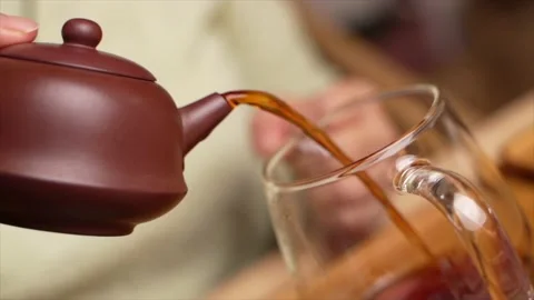 Pouring tea from a small pot Stock Footage 217369759