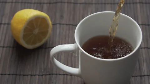 Pouring tea into tea cup. Breakfast Stock Footage 126836581