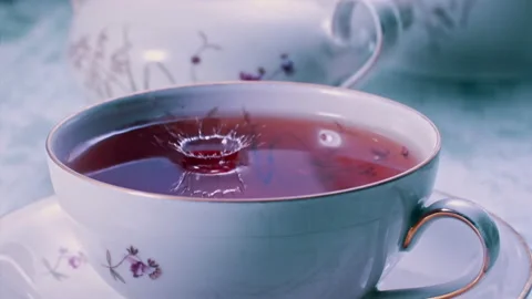 Pouring Tea in Tea Cup on the Table Super slow motion 1000fps Stock Footage 130983828
