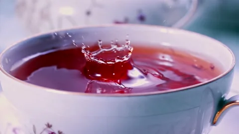 Pouring Tea in Tea Cup on the Table Super slow motion 1000fps Stock Footage 130984081