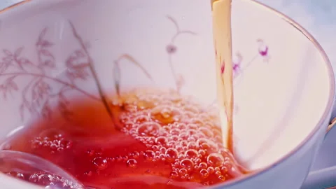 Pouring Tea in Tea Cup on the Table Super slow motion 1000fps Stock Footage 130985758