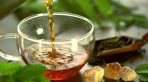 Pouring Tea. Tea Pot and Glass Tea Cup Stock Footage 33913494