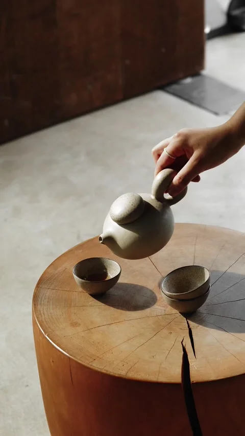 Pouring Tea on a Teacup Stock Footage