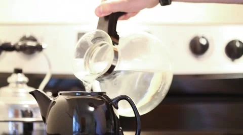 Pouring Tea into Teapot Stock Footage 68669944