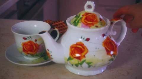 Pouring tea using ceramic tea set close-up 4K Stock Footage 98879160
