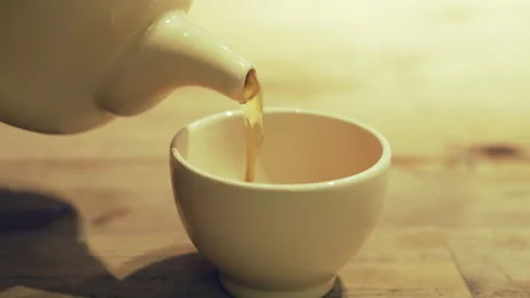 Pouring teapot in tea cup Stock Footage 142954239