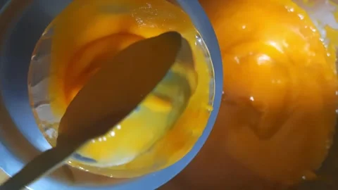 Pouring Thick Mango Pulp into Bowl – Fresh Mango Dessert Serving Close-Up Stock Footage 333054976