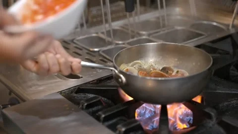 Pouring Tomato Sauce Into Pan While Tossing Seafood Spaghetti Stock Footage 346676806