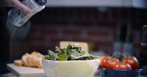 Pouring toppings over toppings of pecans over salad Stock Footage 101598191