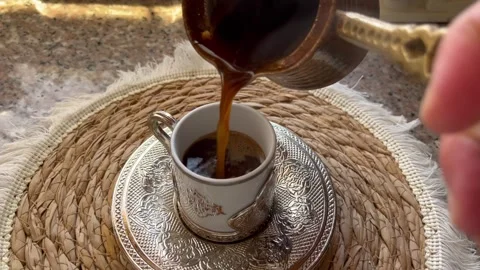 Pouring Traditional Arabic Coffee into an Elegant Cup Stock Footage 345304591