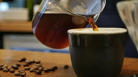 Pouring traditional hot coffee to a cup Stock Footage