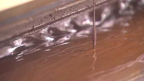 Pouring a trickle of chocolate Stock Footage 94874179
