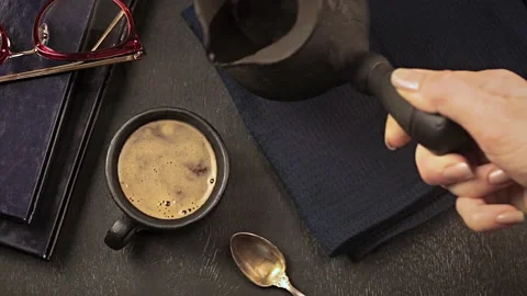 Pouring turkish coffee into black cup Stock Footage 146957930