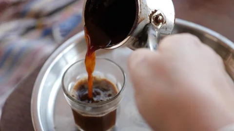 Pouring A Turkish coffee into a traditional glass cups on Nuweiba Sinai Egypt Stock Footage 116980522