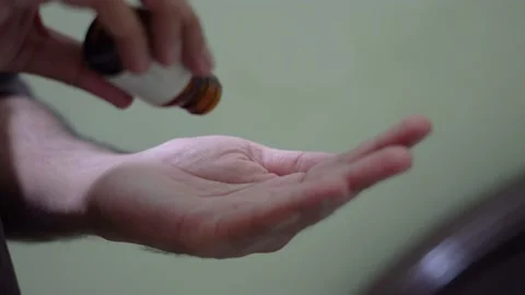 Pouring two pills tablets on palm Stock Footage 139570437
