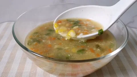 Pouring Vegetable Corn Soup in a Glass Bowl Stock Footage 236774464