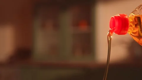 Pouring vegetable oil from plastic bottle close up Видео 335153799