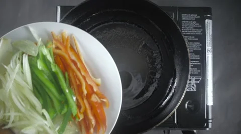 Pouring Vegetables into Pan Stock Footage 61325822