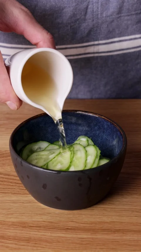 Pouring Vinegar On Cucumbers Front View Видео 331590914