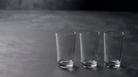 Pouring vodka in glasses close-up. Stock Footage 98973504