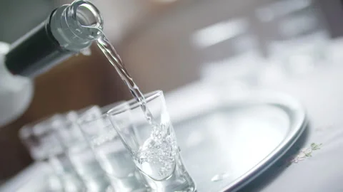 Pouring Vodka into Glasses Close-Up Stock Footage 304871724