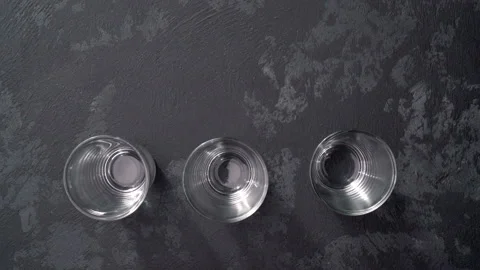 Pouring vodka in glasses close-up,top view Stock Footage 98973149