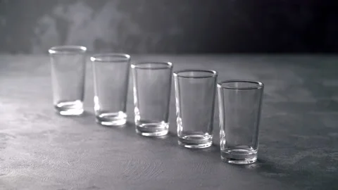 Pouring vodka in glasses close-up. Vodka being poured into a glass Stock Footage 98973232