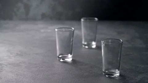 Pouring vodka in glasses close-up. Vodka being poured into a glass Stock Footage 98973662