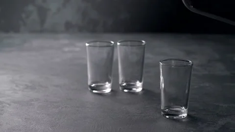 Pouring vodka in glasses close-up. Vodka being poured into a glass Stock Footage 98973674