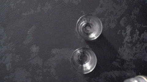 Pouring vodka in glasses close-up. Vodka being poured into a glass Stock Footage 98977302
