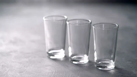 Pouring vodka in glasses close-up. Vodka being poured into a glass Stock Footage 98977331